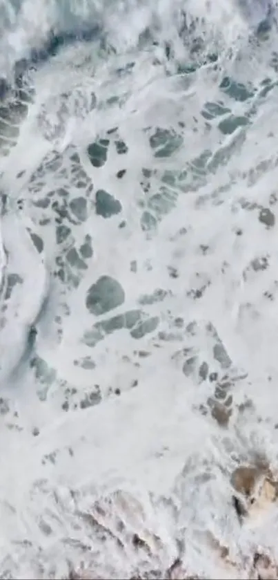 Aerial view of ocean waves with intricate water patterns.