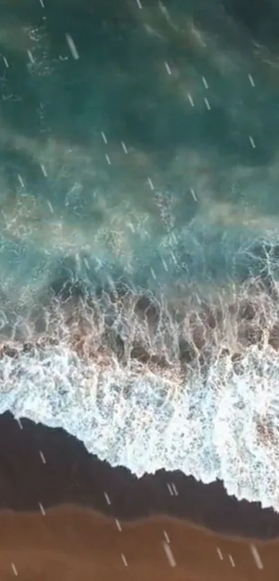 Aerial view of turquoise ocean waves crashing onto a sandy beach.