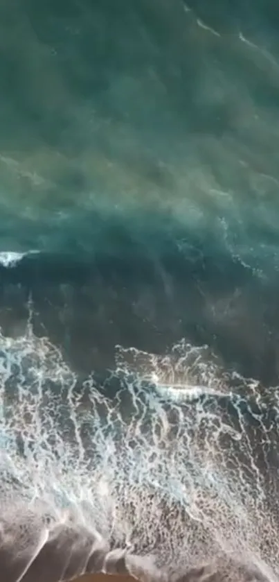 Aerial view of ocean waves crashing on the beach.