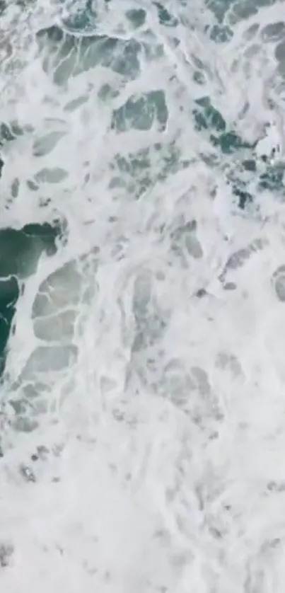 Aerial view of ocean waves with foamy white textures.