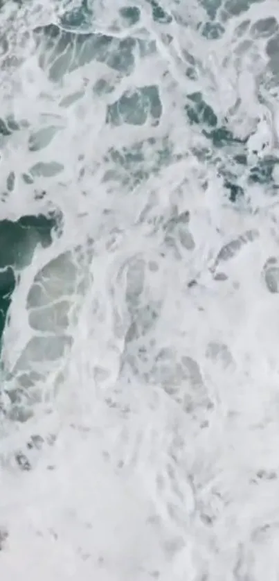 Vibrant ocean waves creating a dynamic pattern with white foam and teal water.