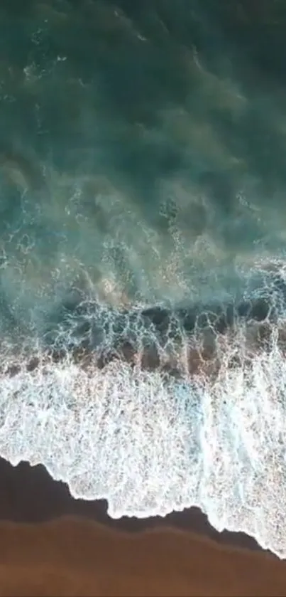 Aerial view of ocean waves crashing onto the shoreline.