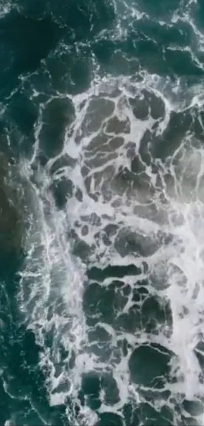 Aerial view of ocean waves creating textured patterns on the sea surface.