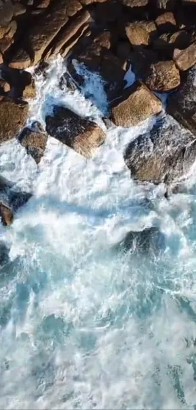 Aerial view of ocean waves crashing against coastal rocks.