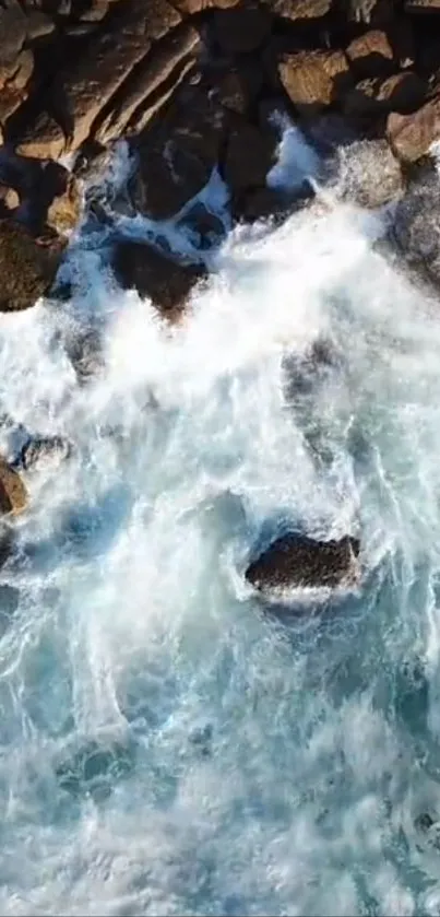 Aerial view of ocean waves crashing over rocks