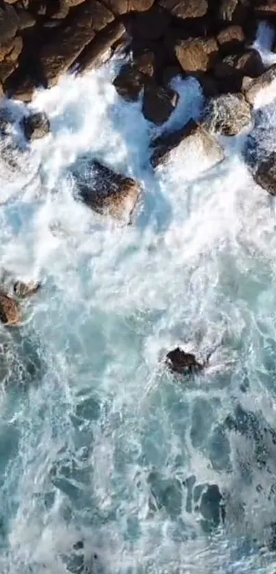 Aerial view of ocean waves crashing on rocks.