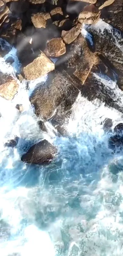 Ocean waves crashing against rocks from above.