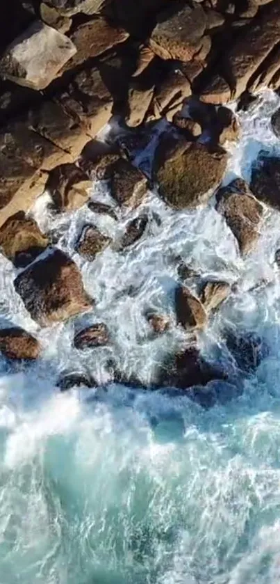 Aerial view of ocean waves crashing against rocky shore.