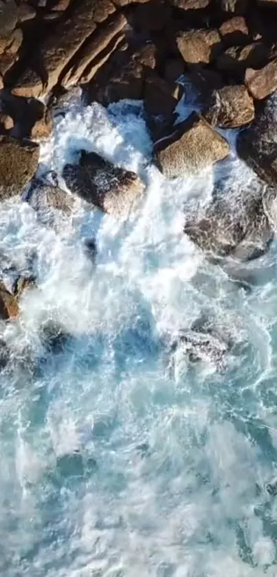 Bird's-eye view of waves crashing against rocky shore.