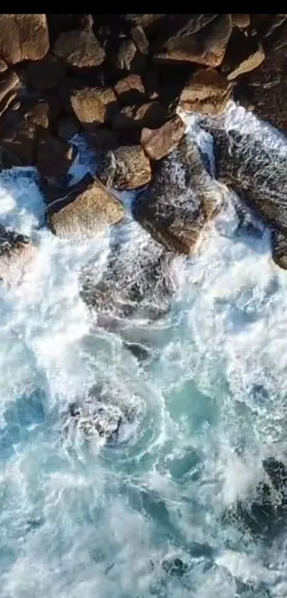 Aerial view of ocean waves crashing on rocks.