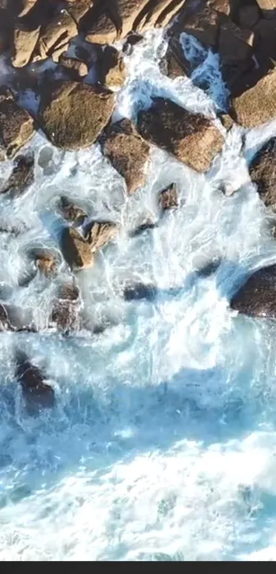 Aerial view of ocean waves crashing over rocks.