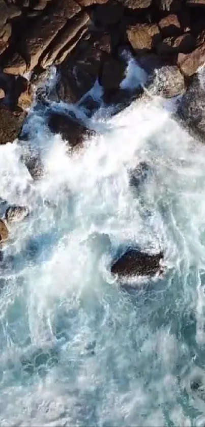 Aerial view of ocean waves crashing against rocks.