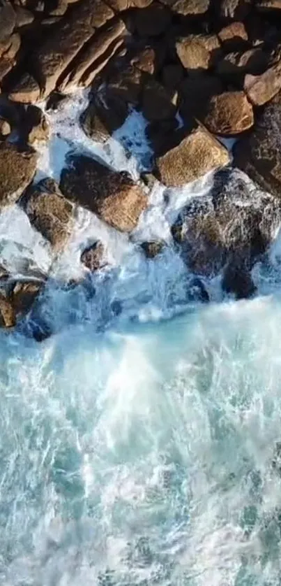 Aerial view of ocean waves crashing on rocky shore.