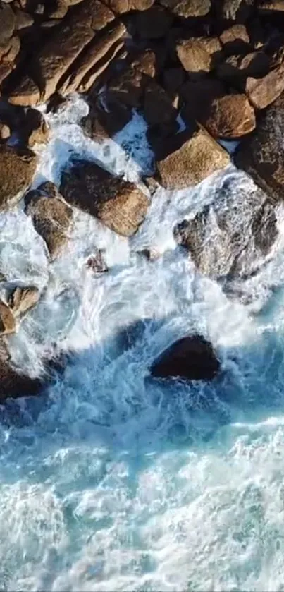 Aerial view of ocean waves crashing over rocks.