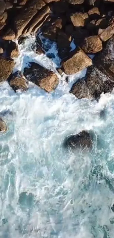 Aerial view of waves hitting rocky shoreline.