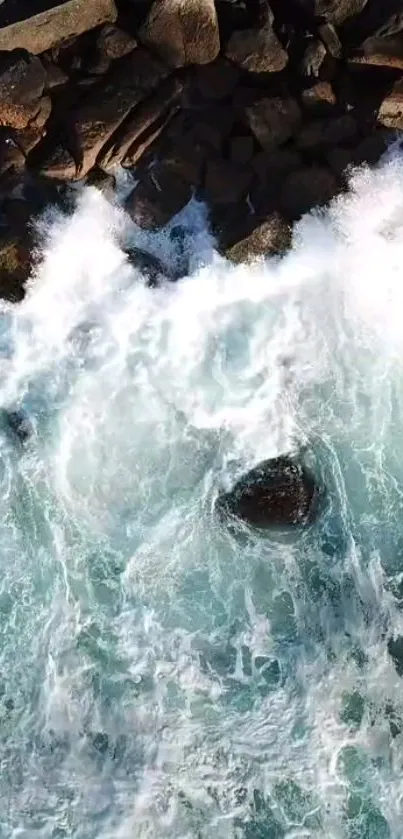 Aerial view of ocean waves hitting rocks.