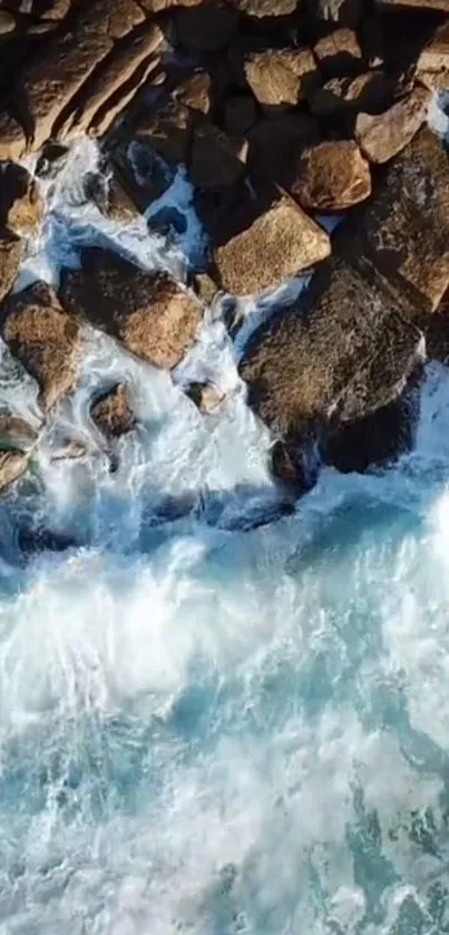 Aerial view of ocean waves crashing on rocky shoreline.