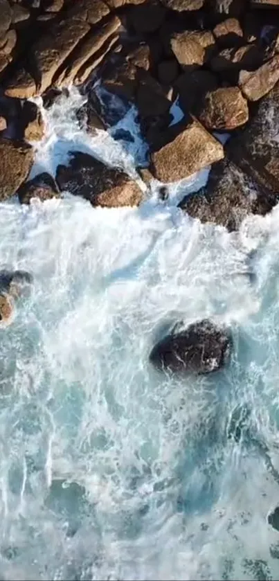 Aerial view of ocean waves crashing onto rocky shoreline.