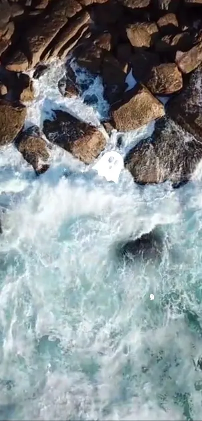 Aerial view of ocean waves crashing on rugged rocks.