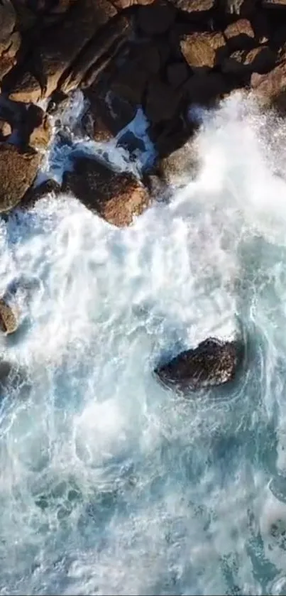 Aerial view of ocean waves crashing on rocky coastline.