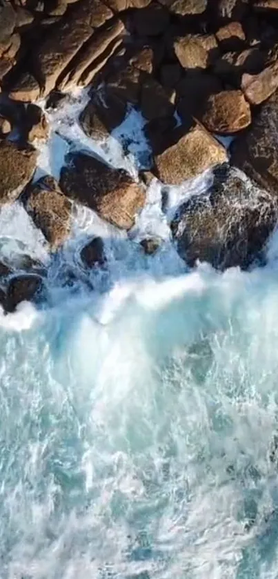 Aerial view of ocean waves crashing onto rocks.