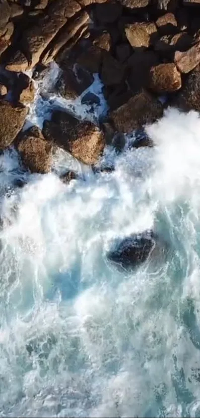 Aerial view of ocean waves and rocky coastline on a sunny day.