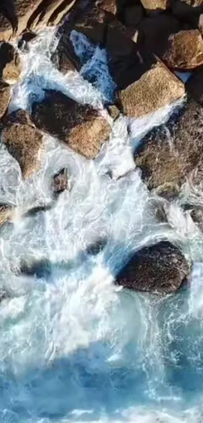 Aerial view of ocean waves crashing on rocks, creating a serene seascape.