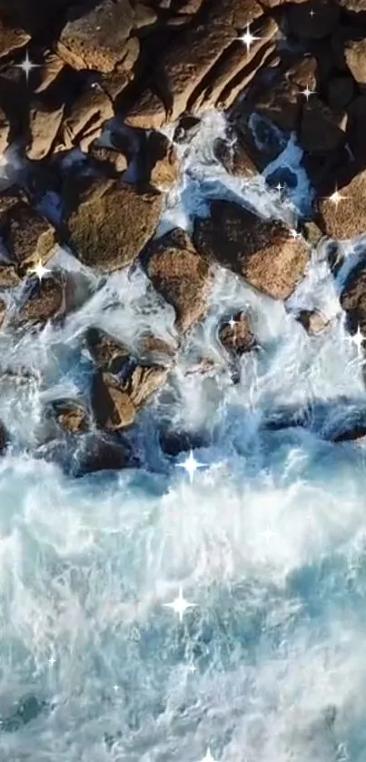 Aerial view of ocean waves crashing onto rocky shore with sparkling accents.