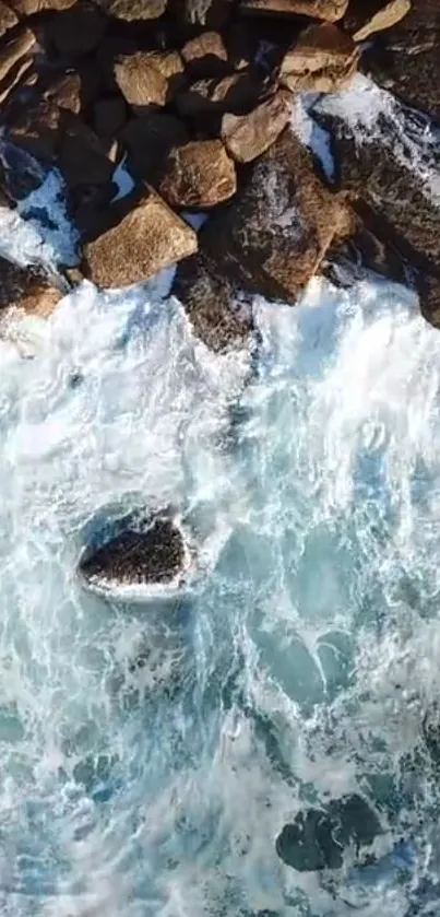 Aerial view of ocean waves crashing against rocks.