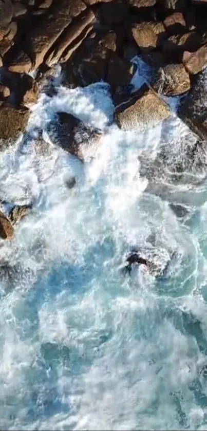 Aerial view of ocean waves hitting rocks.