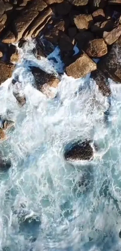 Aerial view of ocean waves hitting rocky shores.