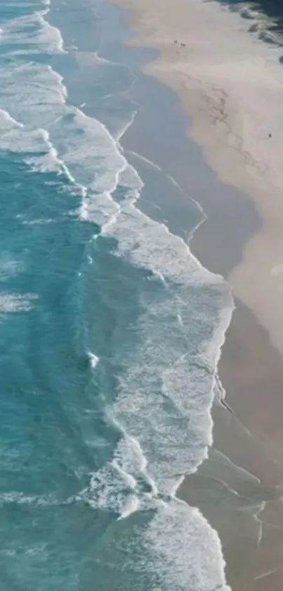 Serene ocean waves along a sandy beach with clear blue water.