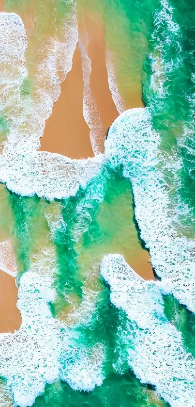 Aerial view of turquoise ocean waves meeting a golden sandy beach.