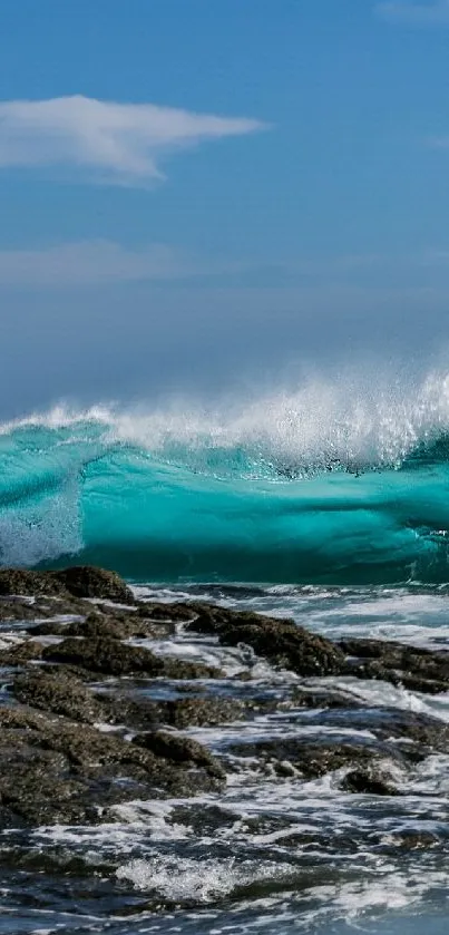 A stunning turquoise wave crashing on rocky shores under a clear blue sky.