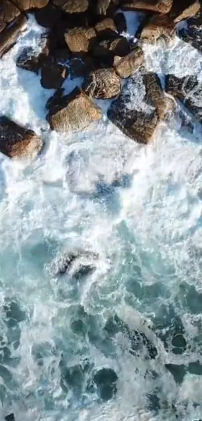 Aerial view of ocean waves crashing on rocky coastline.