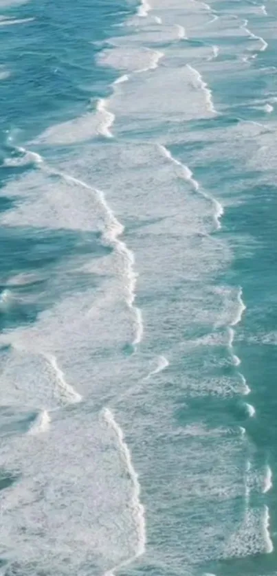 Aerial view of ocean waves and turquoise water, creating a serene mobile wallpaper.