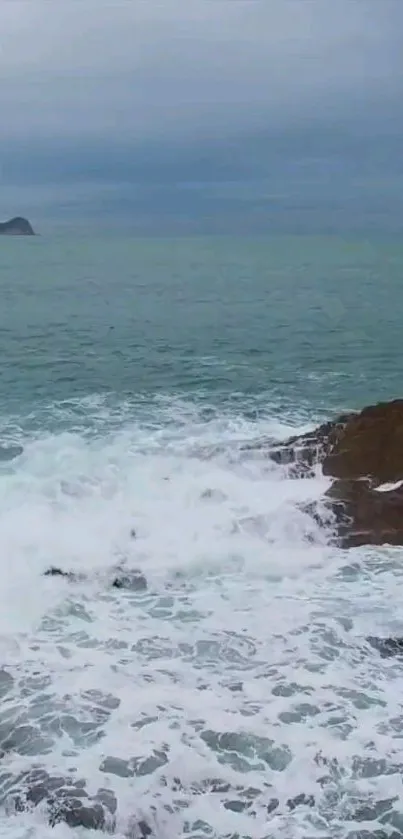 Moody ocean waves crashing against rocky shore.