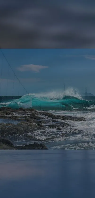 Ocean waves crash against rocky shore under a bright blue sky.