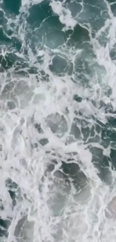 Aerial view of ocean waves with white foam.