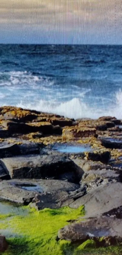 Ocean waves crash against a rocky shore with vibrant moss.