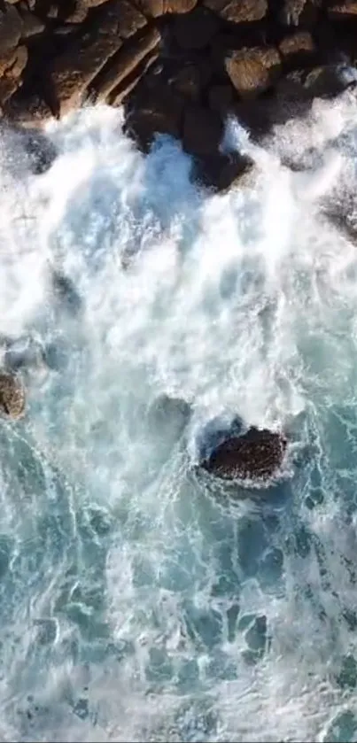 Aerial view of ocean waves crashing on a rocky shore, showcasing natural beauty.