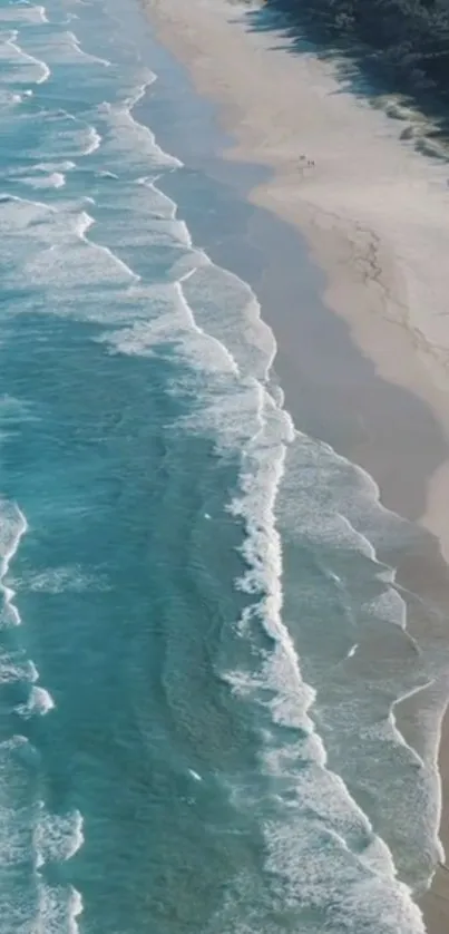 Turquoise ocean waves crashing on a peaceful sandy beach.