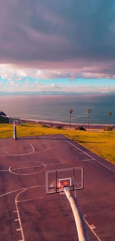 An oceanfront basketball court with a scenic sunset sky.