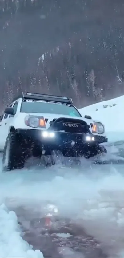 White 4x4 truck off-roading in snowy mountains.