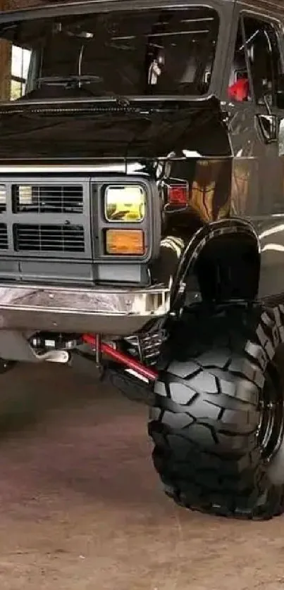 Rugged off-road van in a rustic garage setting with massive tires.