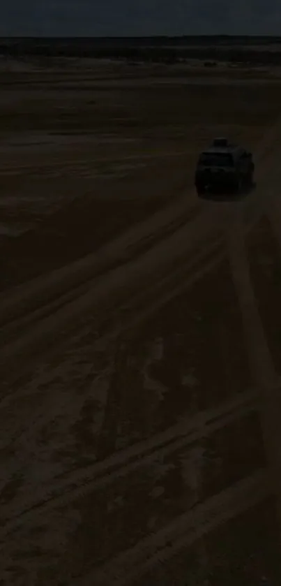 Offroad vehicle traveling on sandy desert landscape.