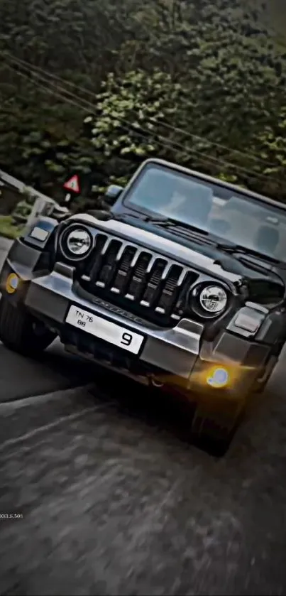 Sleek black Jeep driving on a forest road.