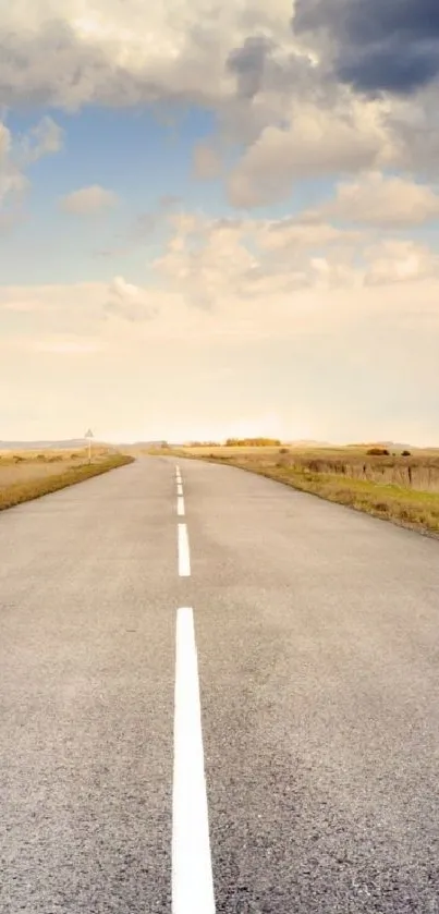 Vast open road under a serene sky with clouds.