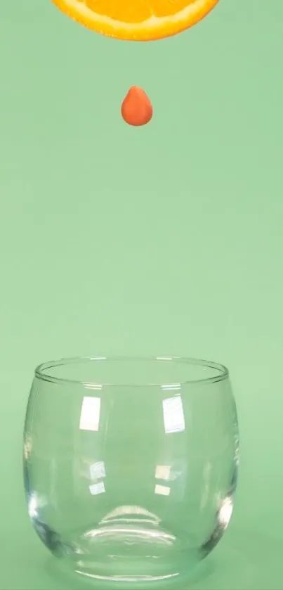 Mint background with glass and orange slice drop, minimalist style