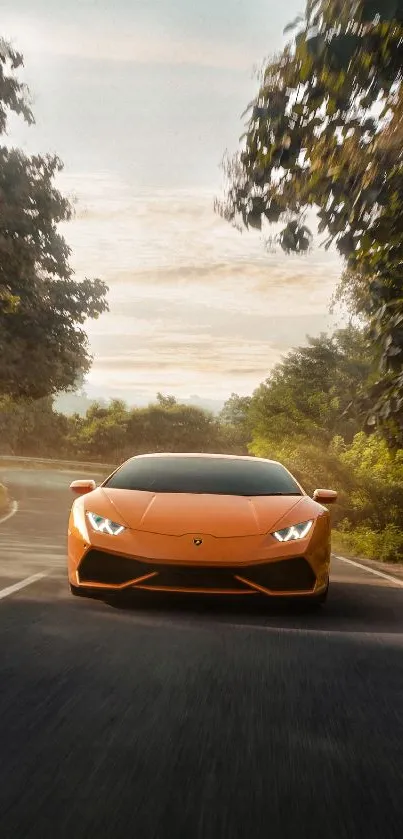 Orange Lamborghini driving on scenic tree-lined road.